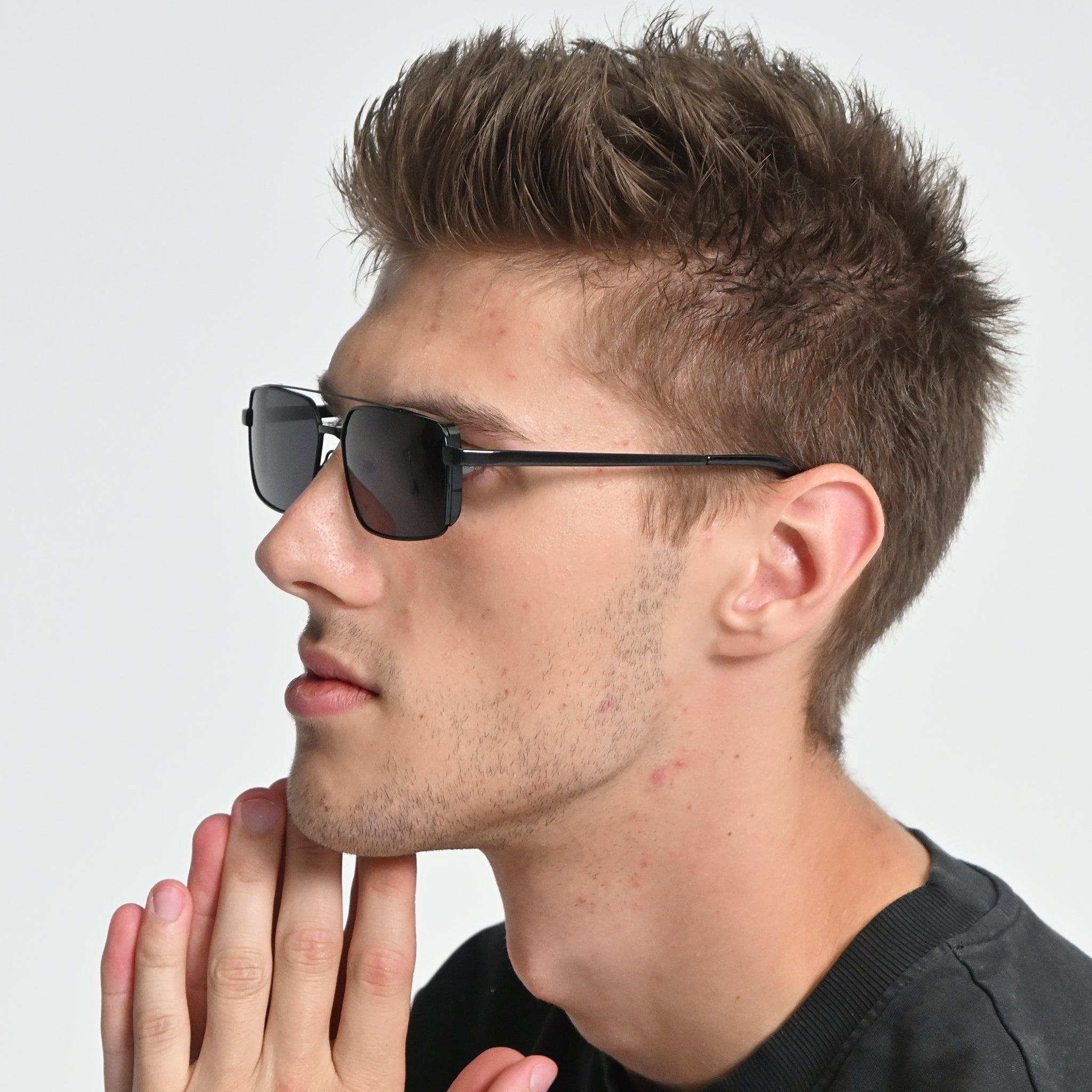 Man wearing sunglasses with a neutral background