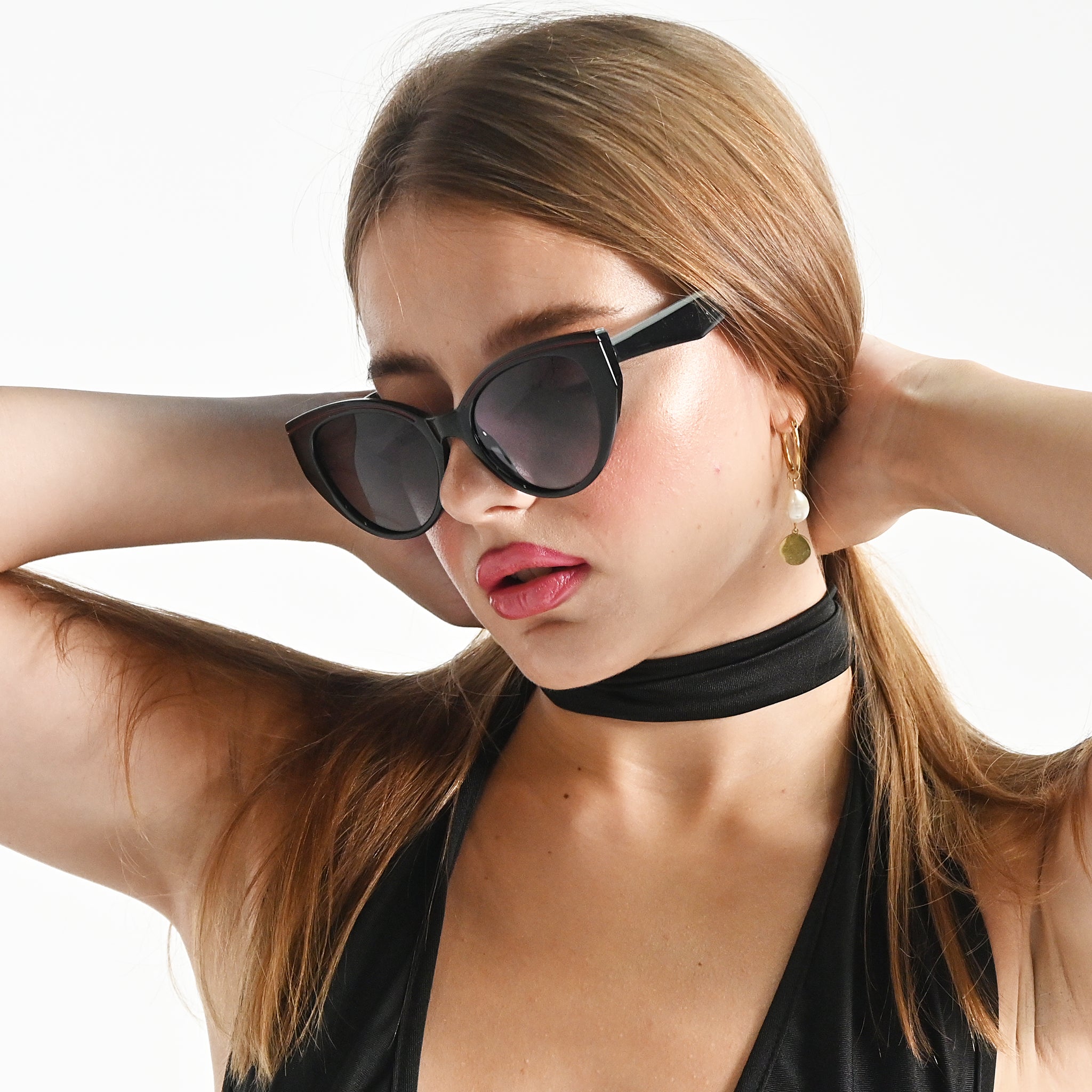 Woman wearing sunglasses with a neutral background
