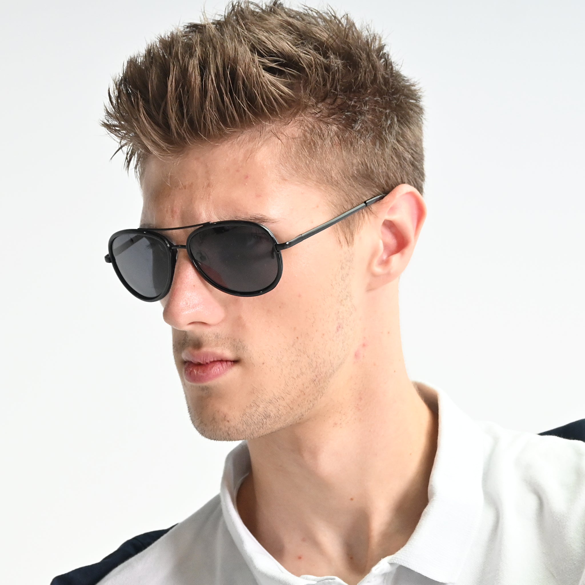 Man wearing black sunglasses with a white background