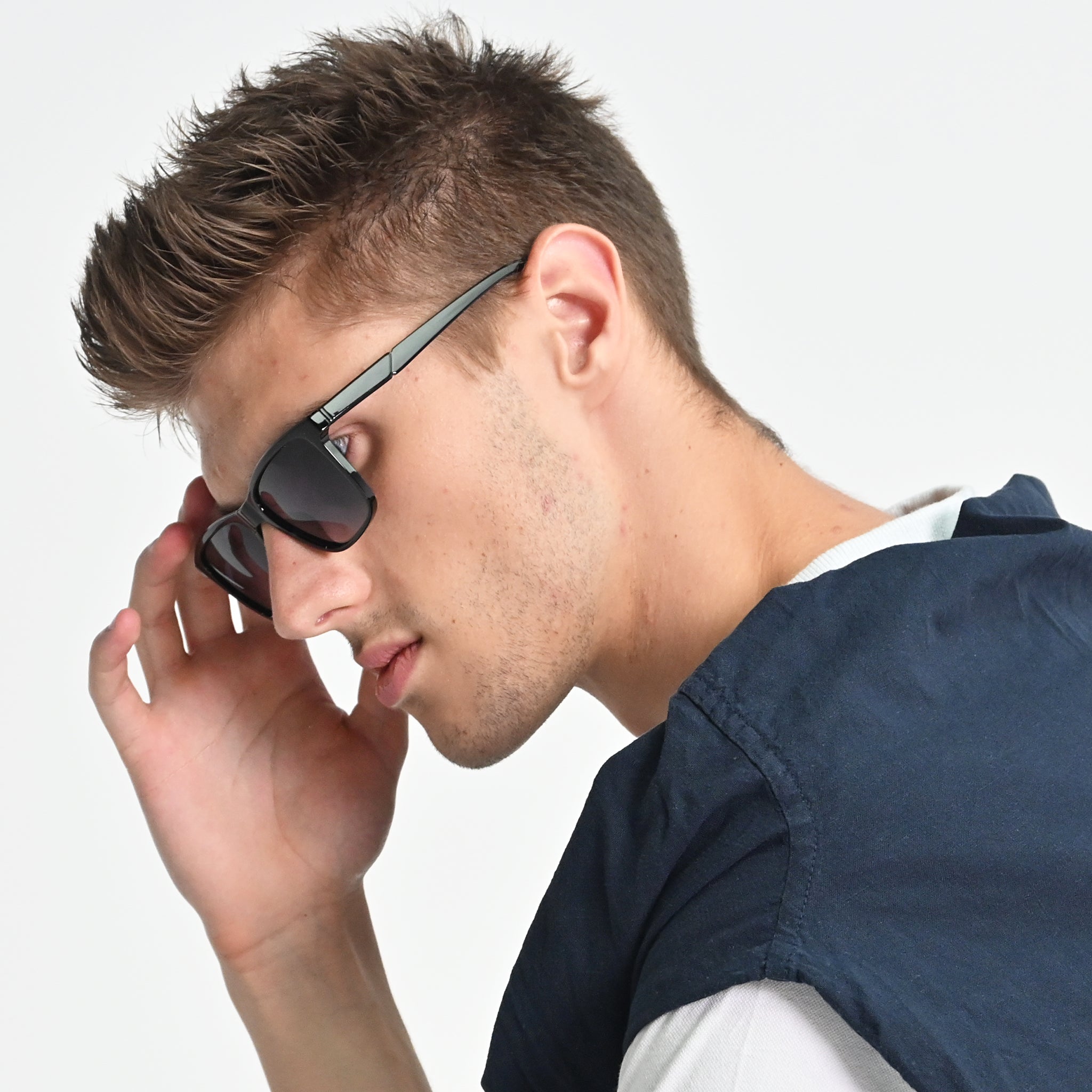 Man wearing sunglasses with a neutral background