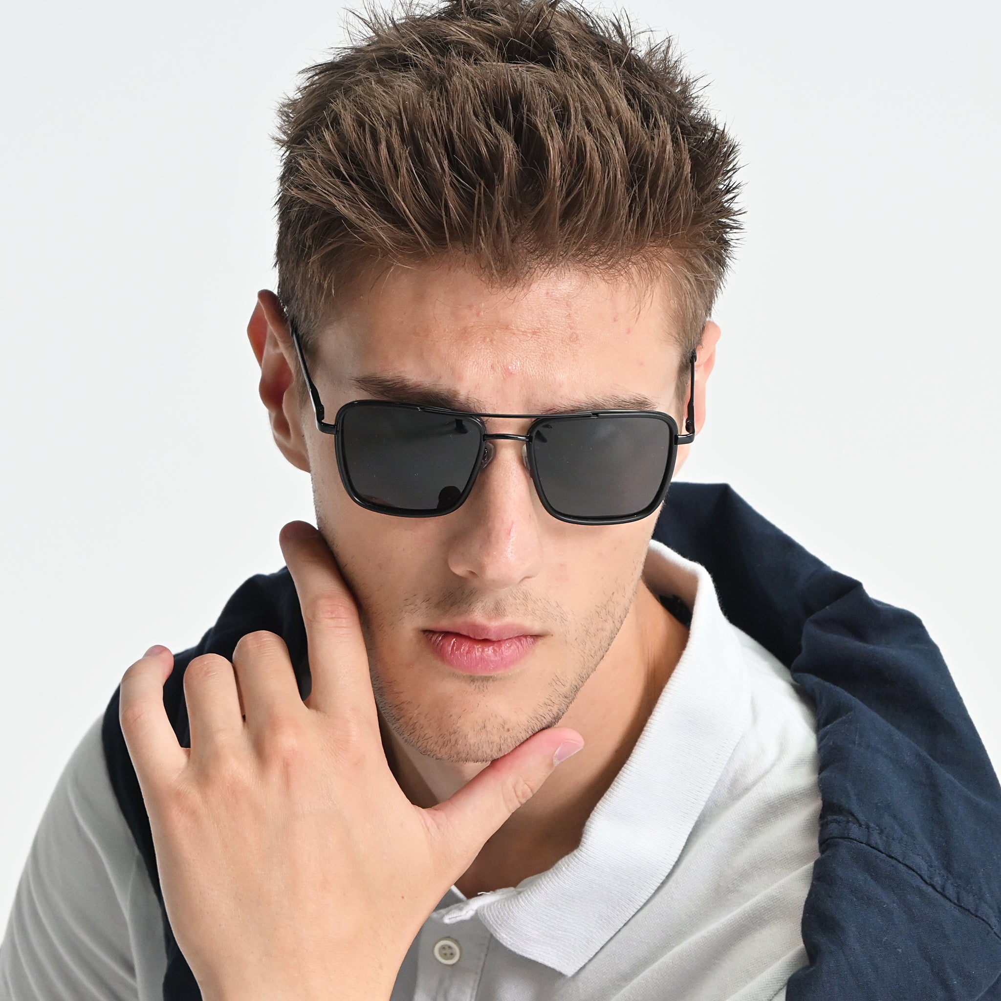 Man wearing sunglasses with a neutral background