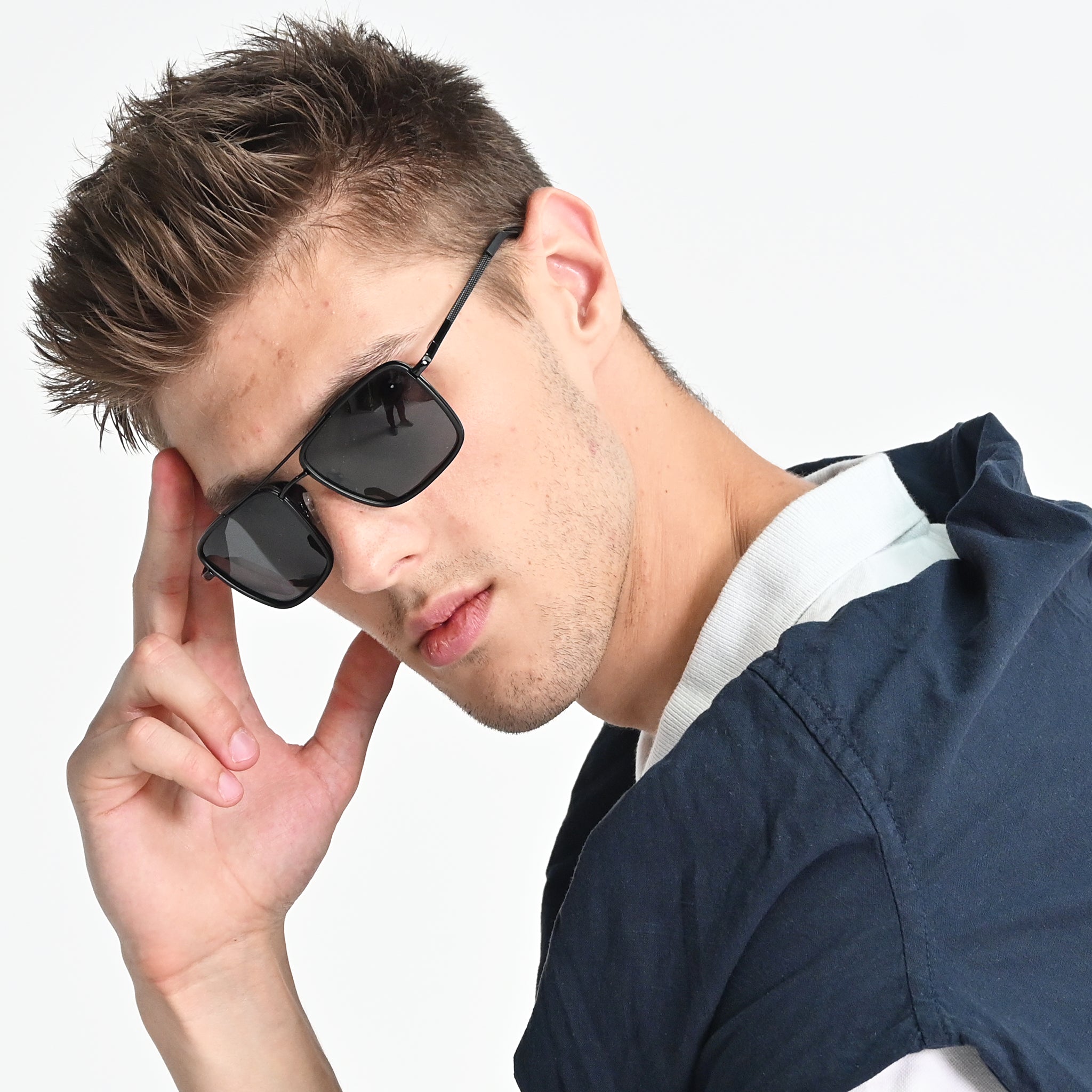 Man wearing sunglasses with a neutral background