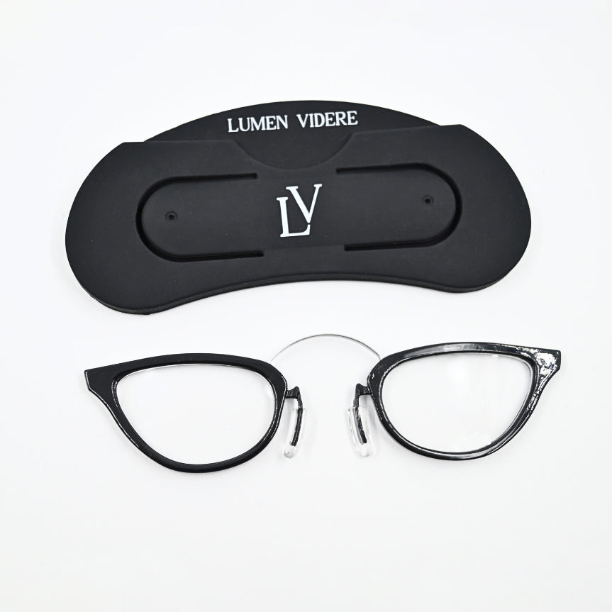 A pair of black cateye style glasses with a silicone holder.