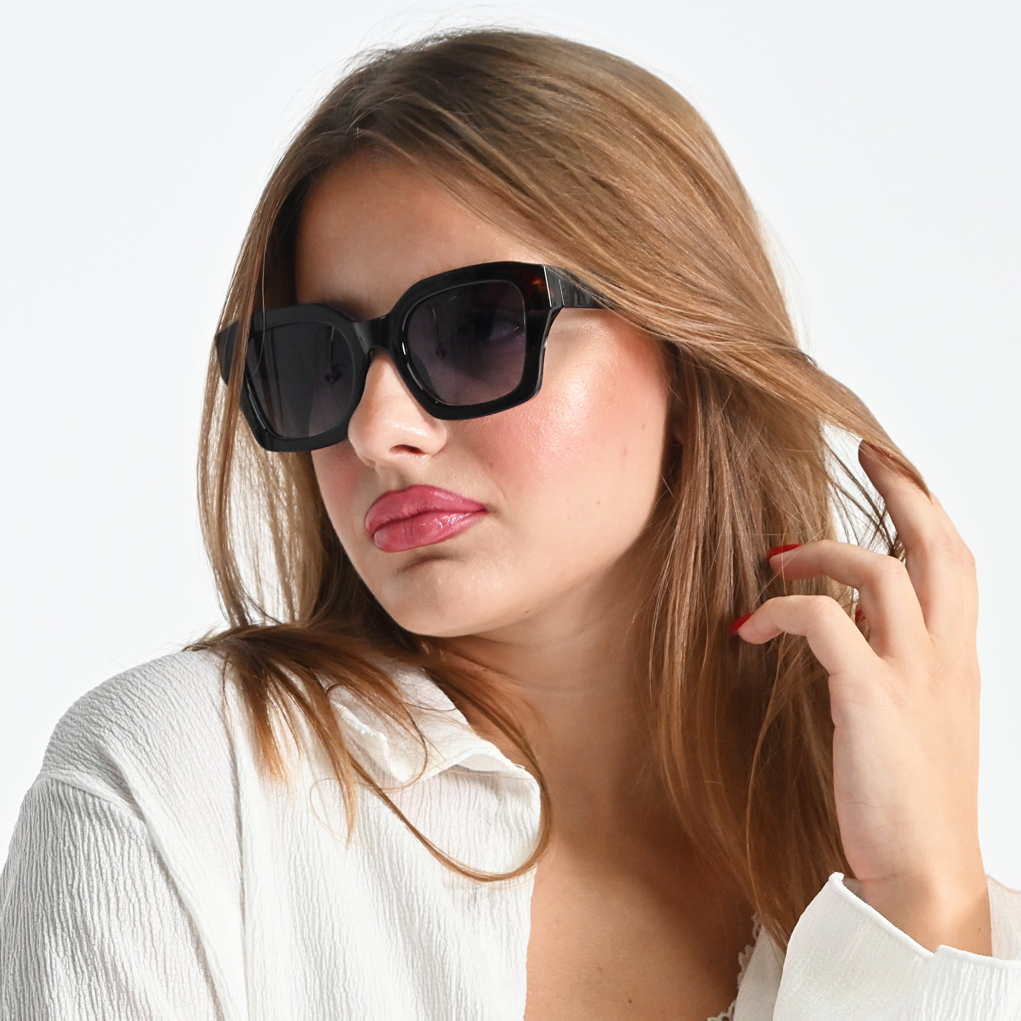 Woman wearing black sunglasses with a plain background