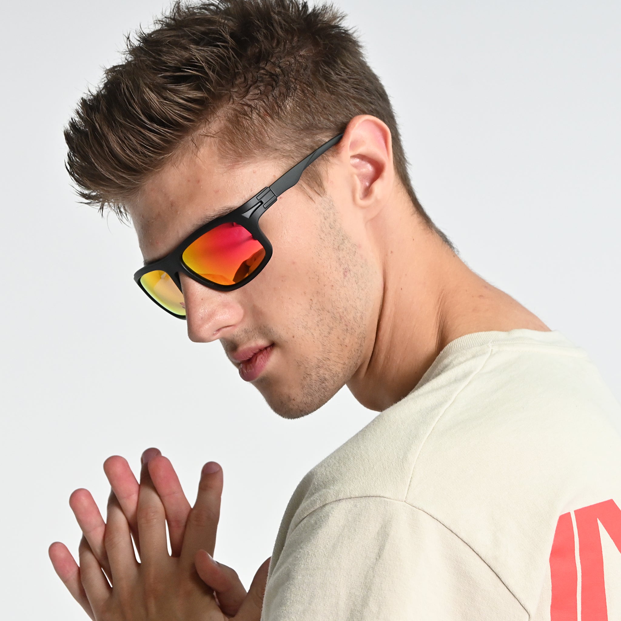 Man wearing reflective sunglasses with a neutral background