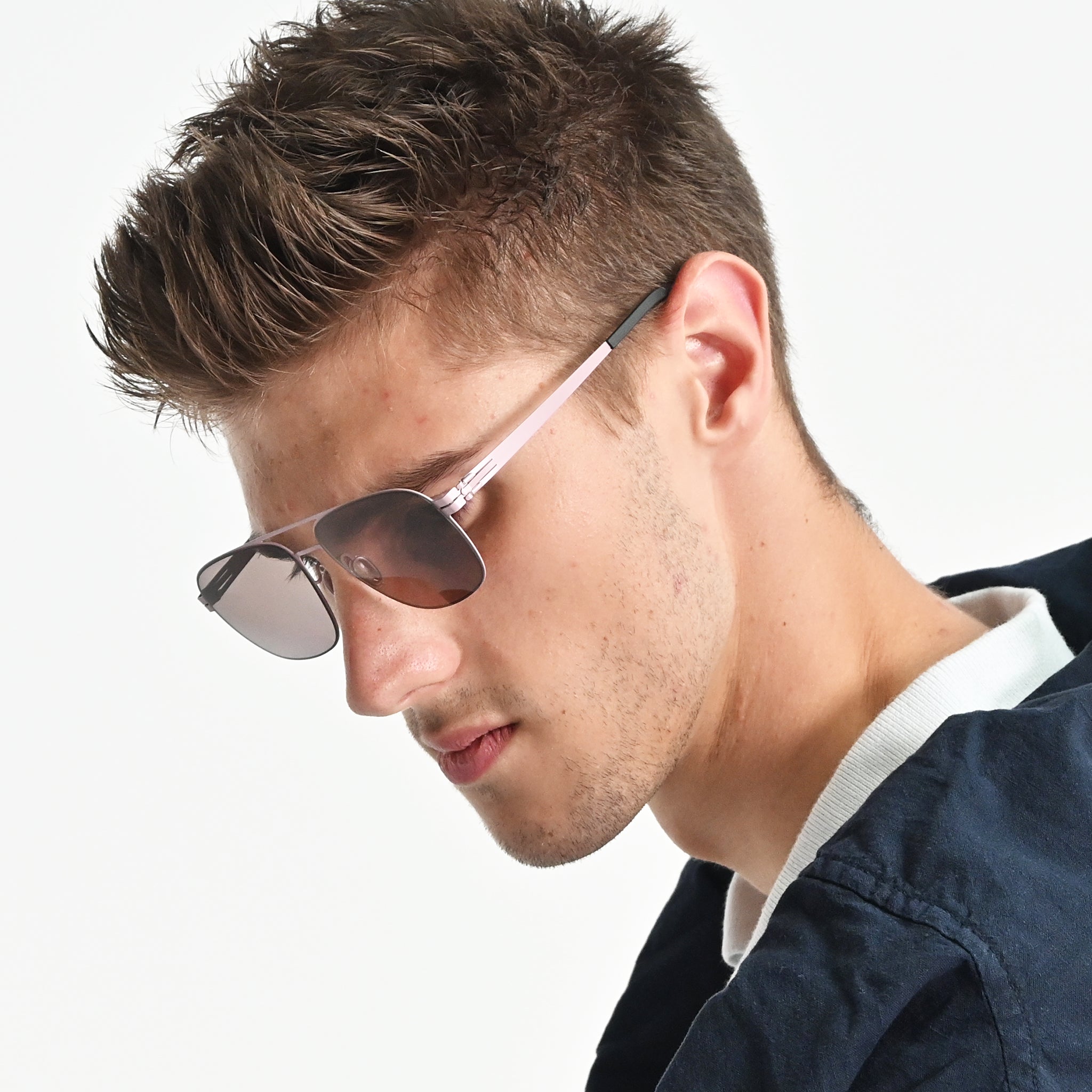 Man wearing sunglasses with a neutral background
