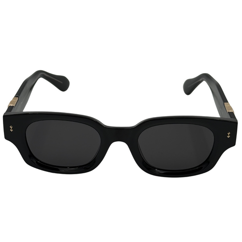 Black sunglasses with gold accents on a white background