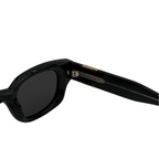 Black sunglasses with a brand logo on a white background