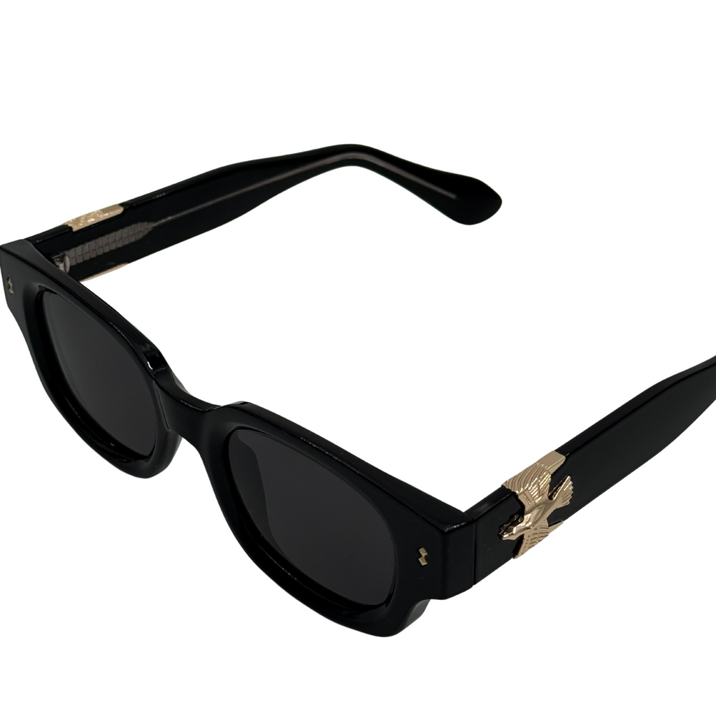 Sunglasses with tortoiseshell frame and eagle emblem on a white background