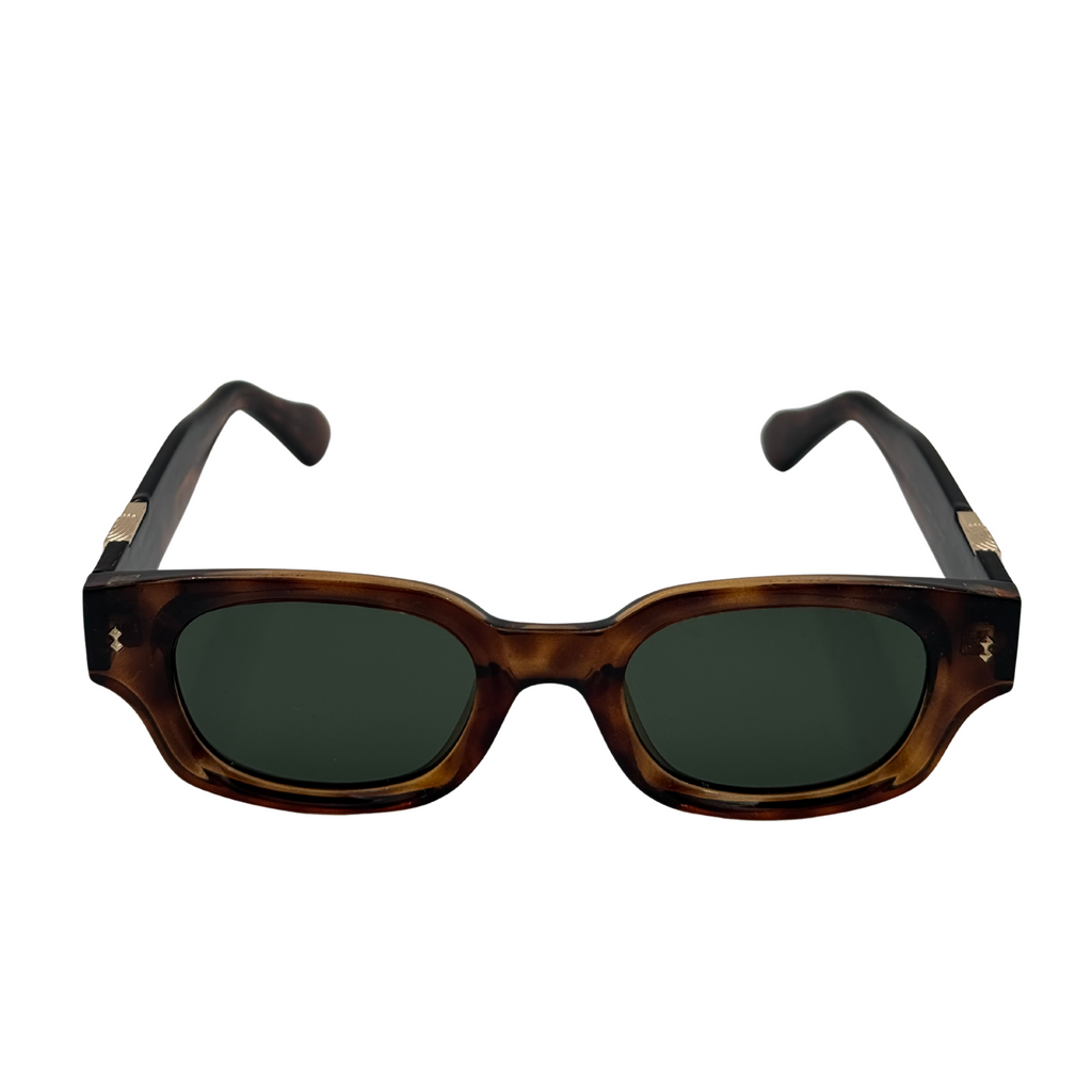 Sunglasses with tortoiseshell frame and dark lenses on a white background