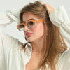 Woman wearing sunglasses with a white background