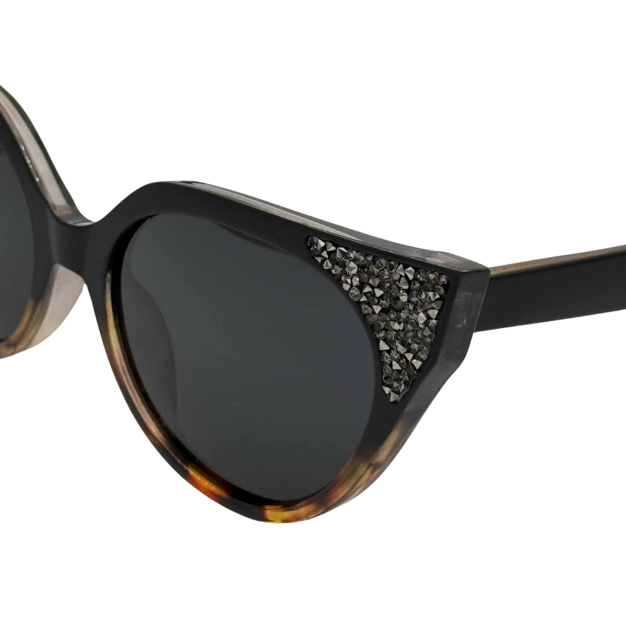 Sunglasses with tortoiseshell frame and embellishments on a white background