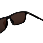 Black sunglasses with brown lenses on a white background