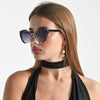 Woman wearing sunglasses and a black halter top on a white background