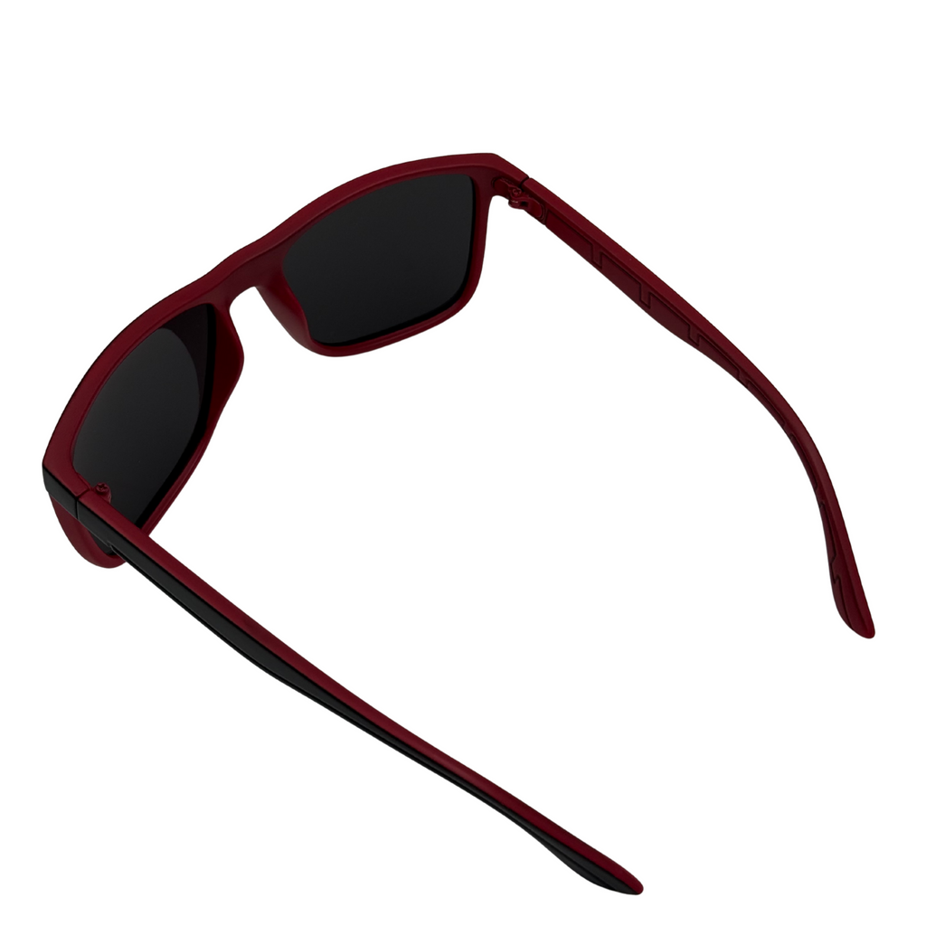 Red sunglasses with black lenses on a white background