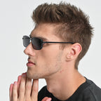 Man wearing sunglasses with a neutral background