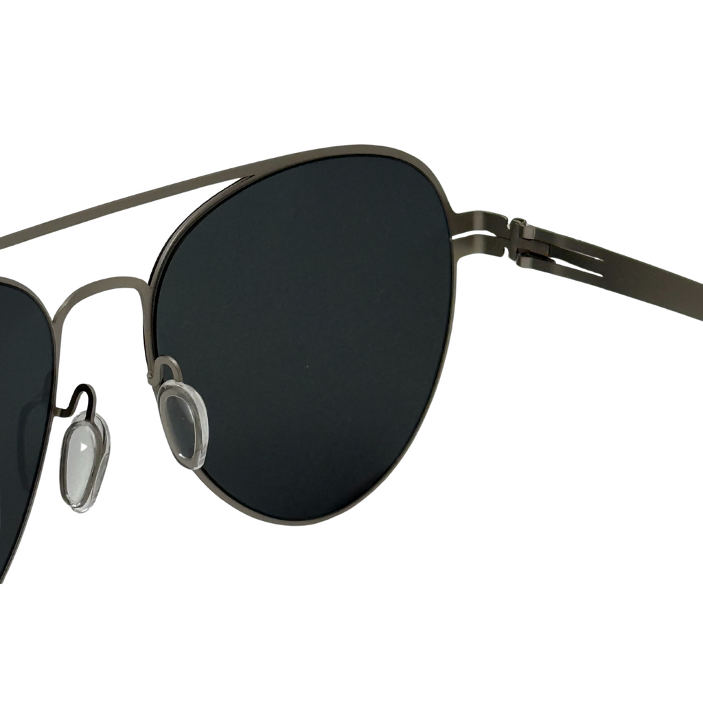 Sunglasses with black lenses and thin metal frame on a white background