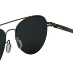 Sunglasses with black lenses and thin metal frame on a white background