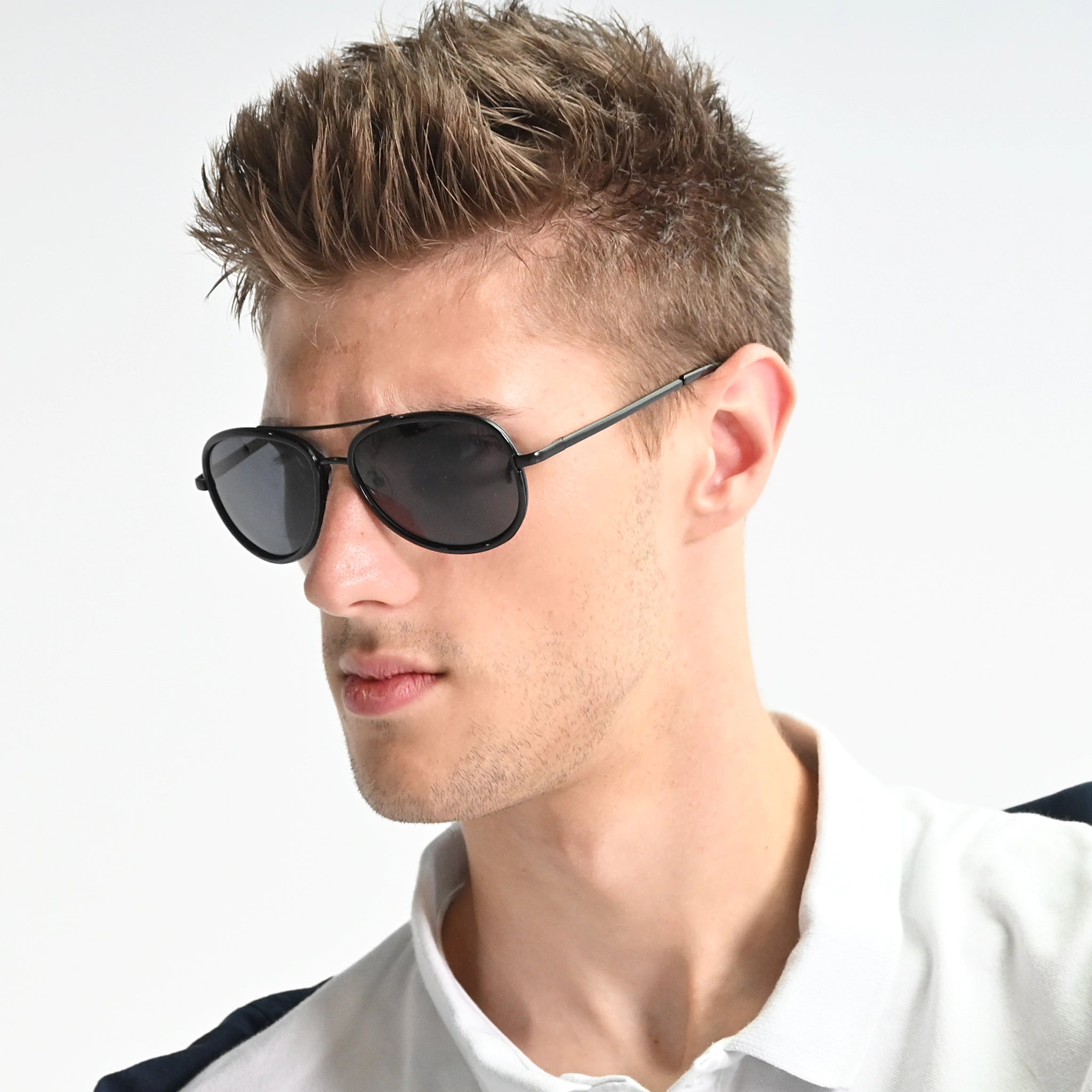 Man wearing sunglasses with a neutral background