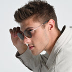 Man wearing sunglasses with a neutral background