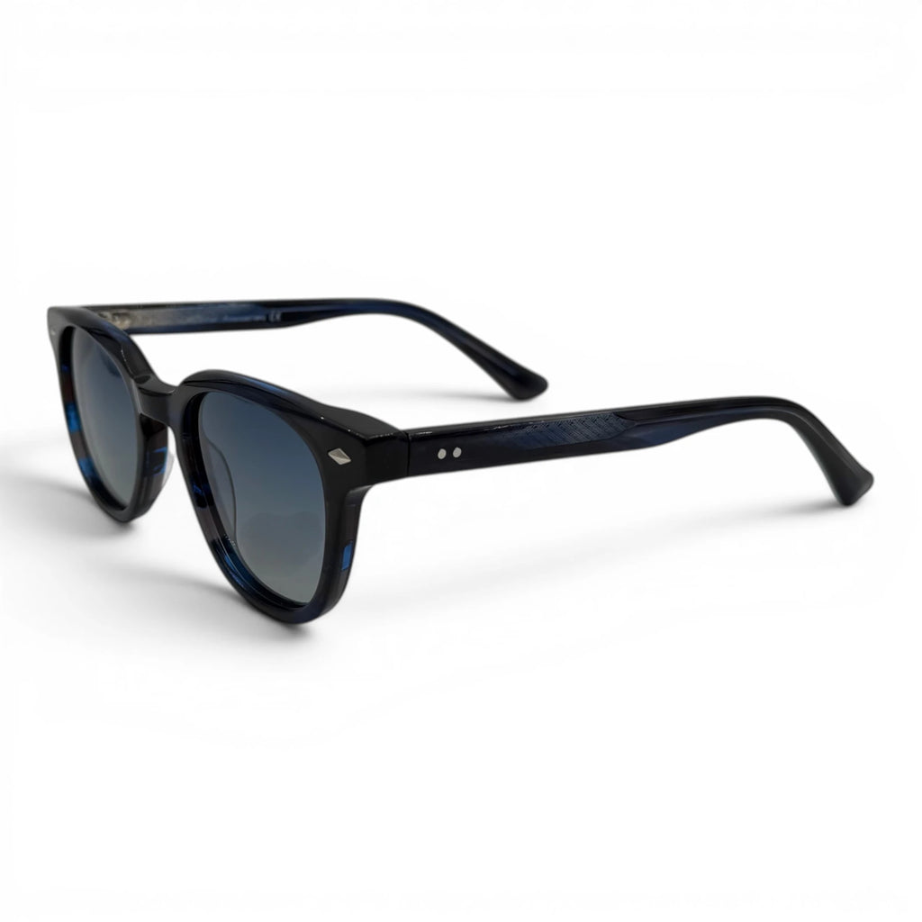 Navy sunglasses with blue-tinted lenses on a white background