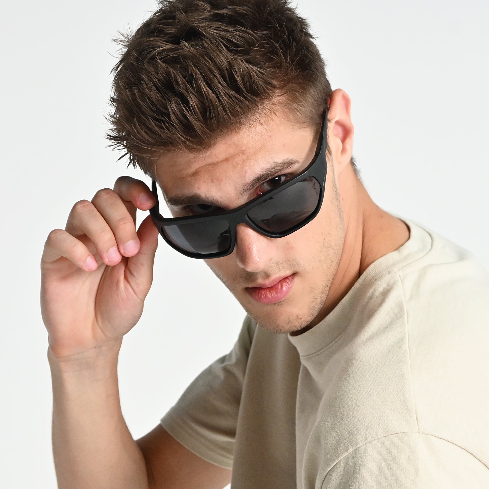 Man wearing sunglasses with a plain background
