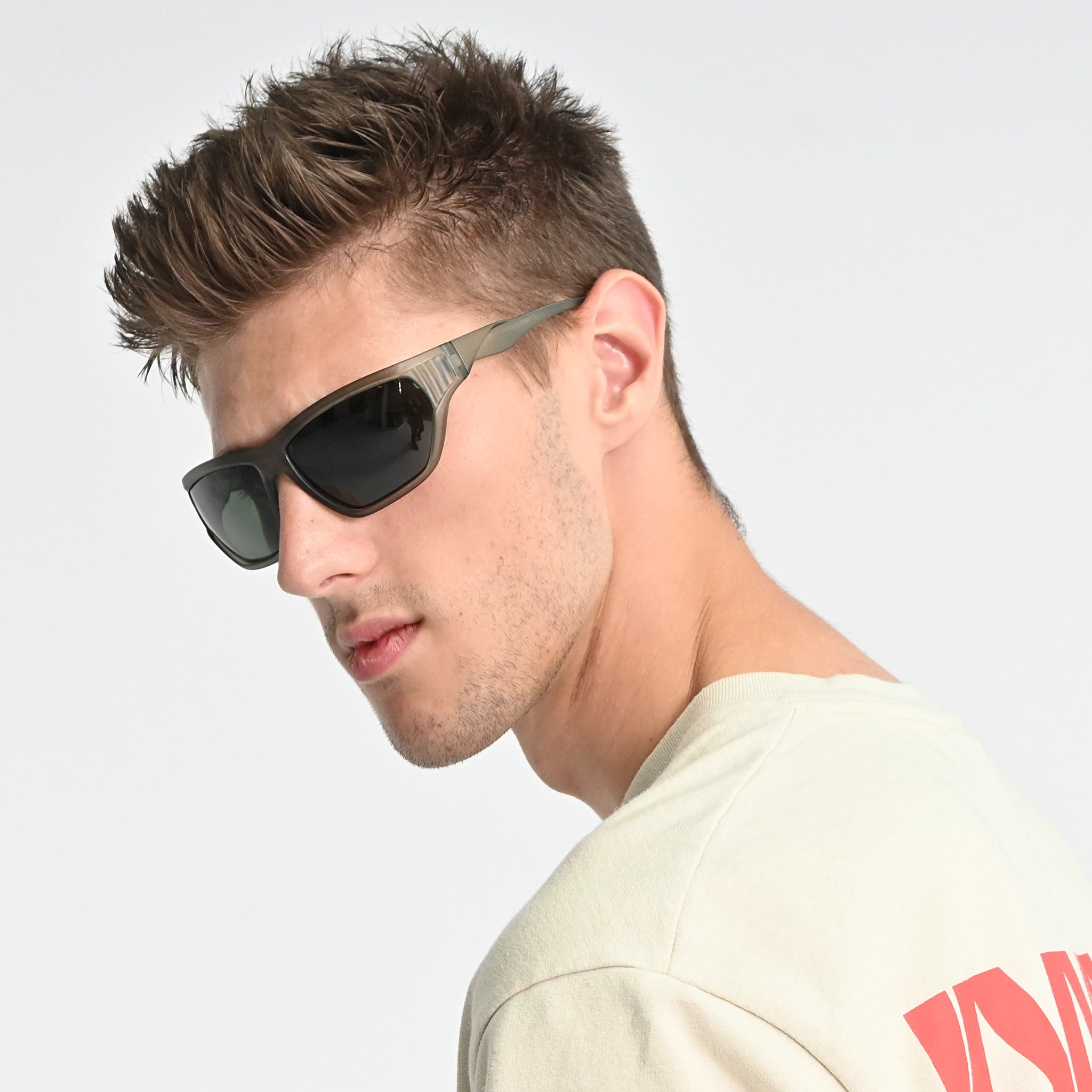Man wearing sunglasses with a neutral background