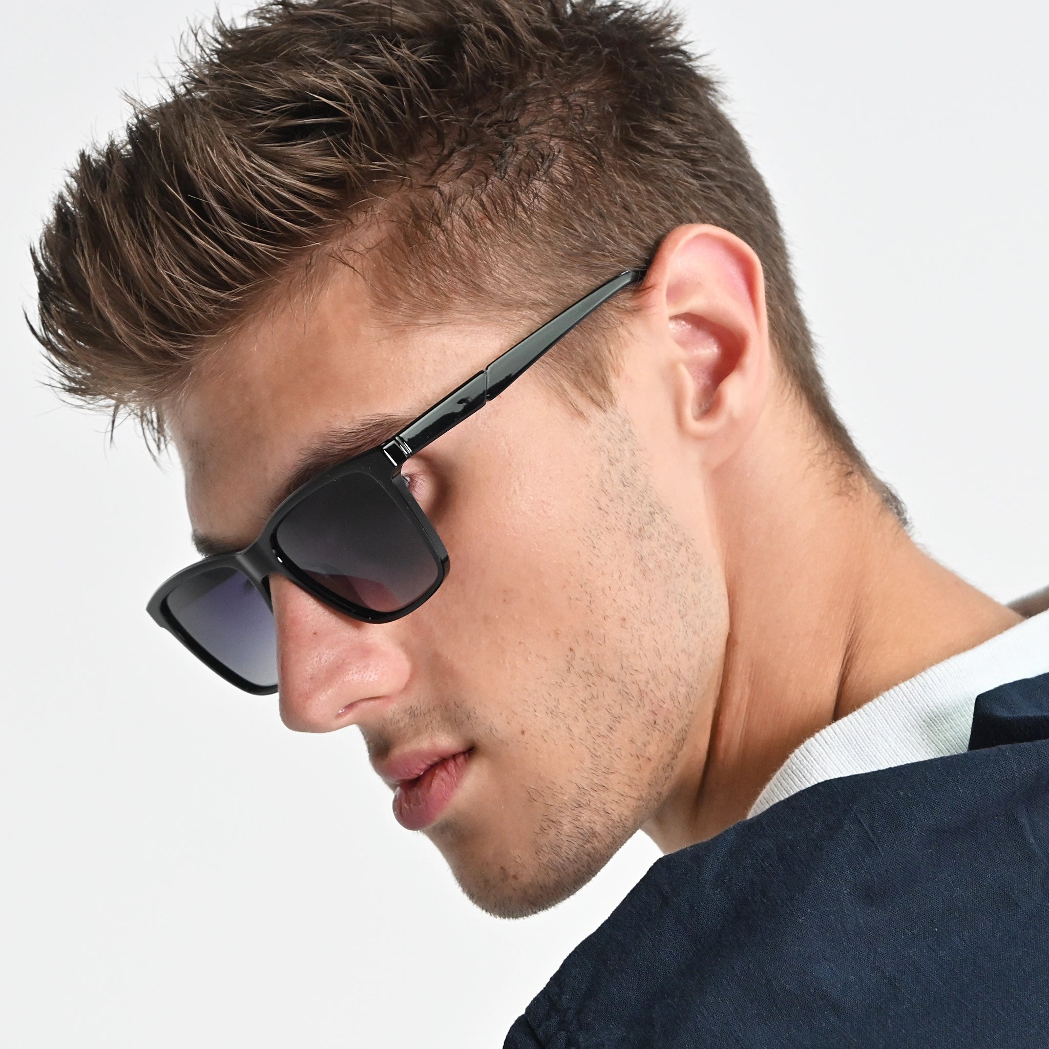 Man wearing sunglasses with a neutral background
