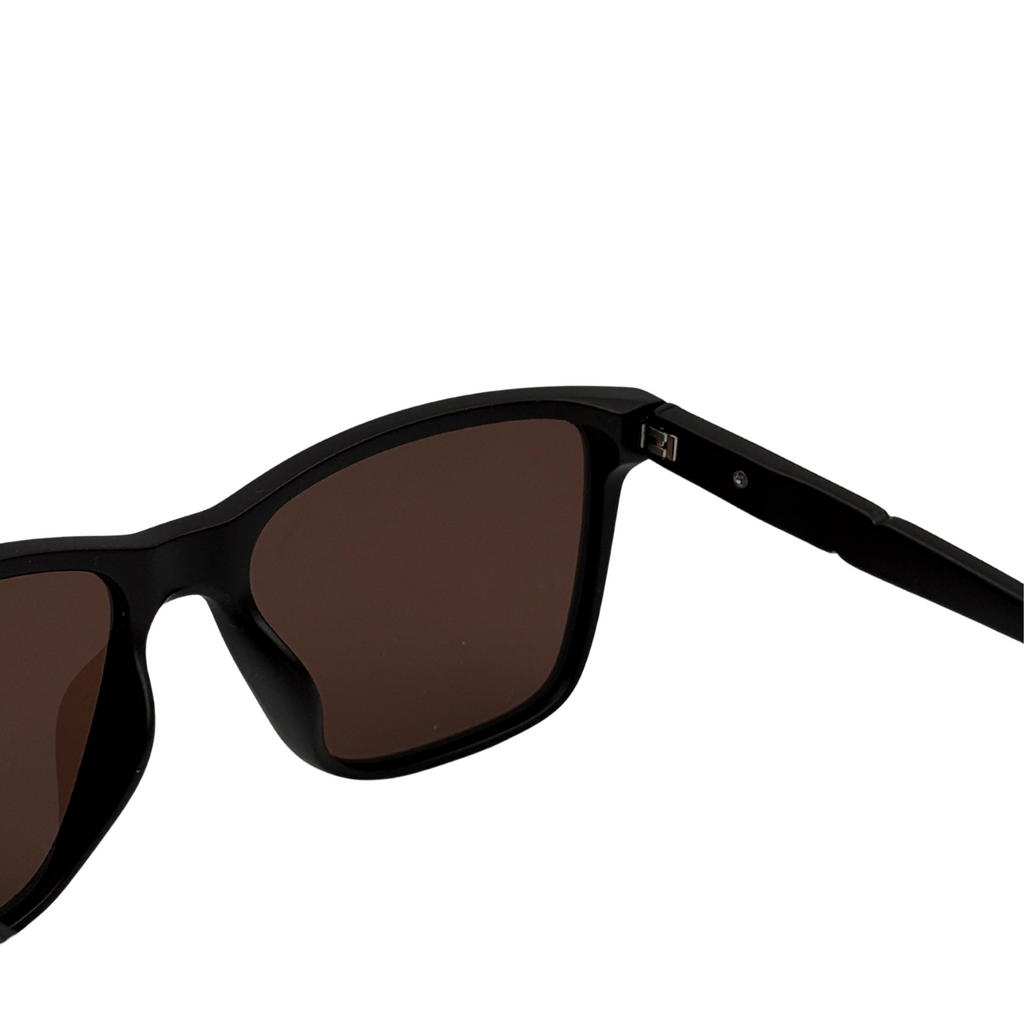 Black sunglasses with brown lenses on a white background