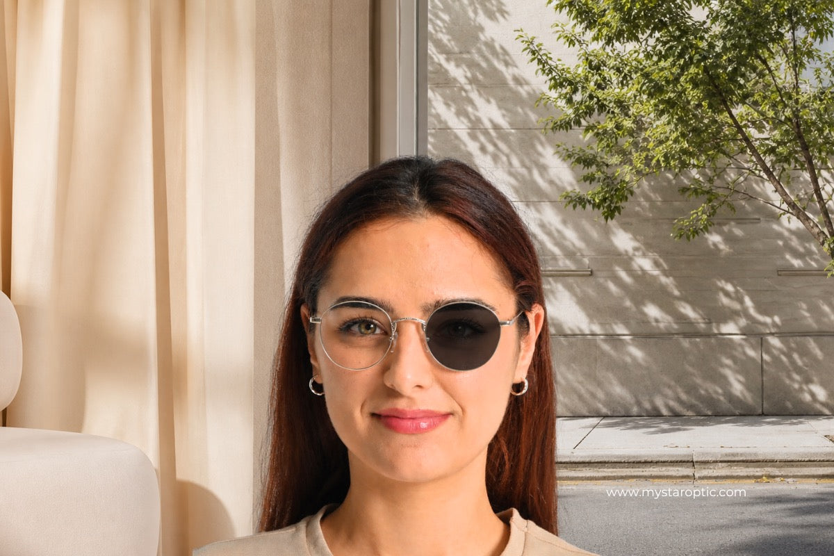 Model wearing round clip-on glasses with one dark sunglass lens and one clear lens, showing indoor and outdoor eyewear use.
