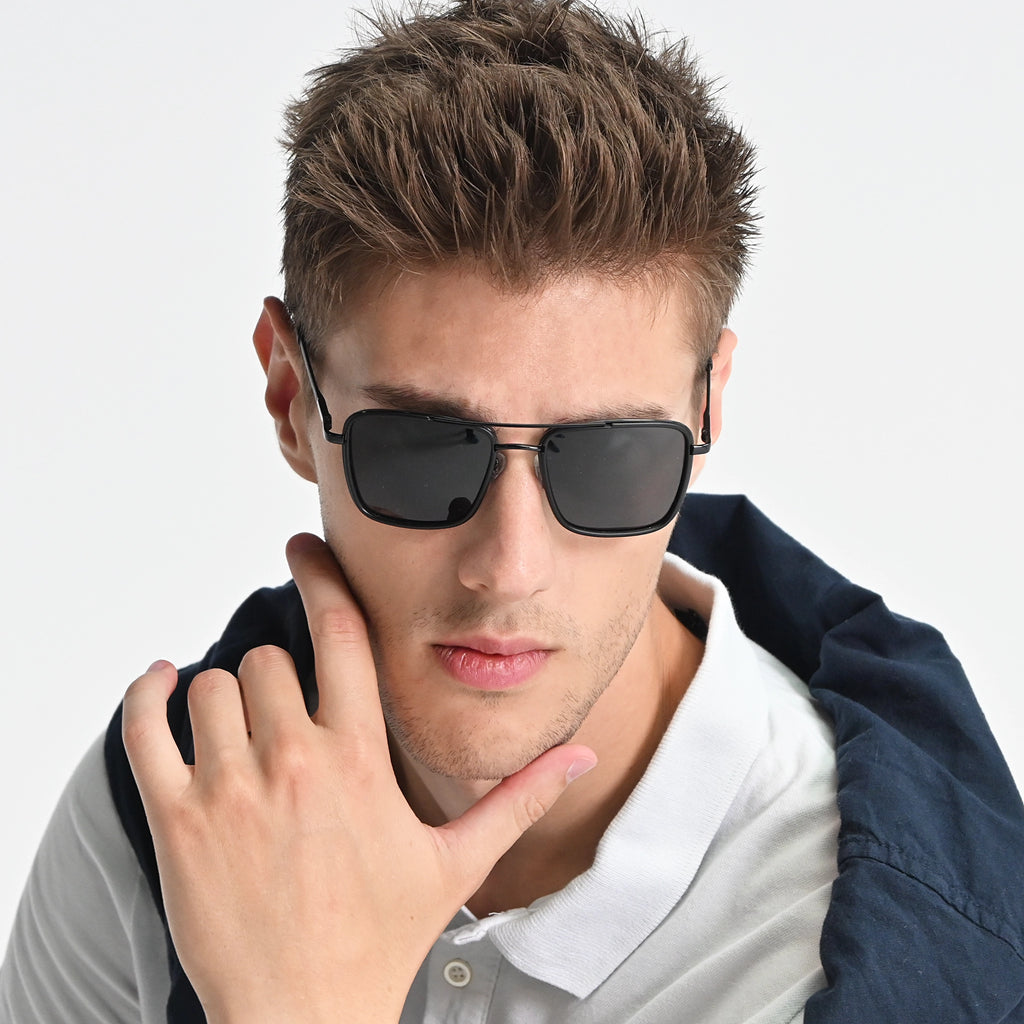 Man wearing sunglasses with a neutral background