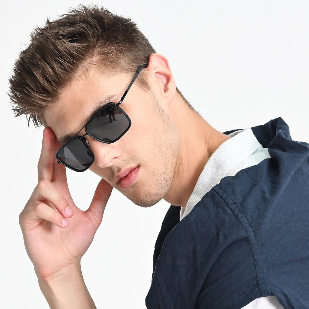 Man wearing sunglasses with a neutral background