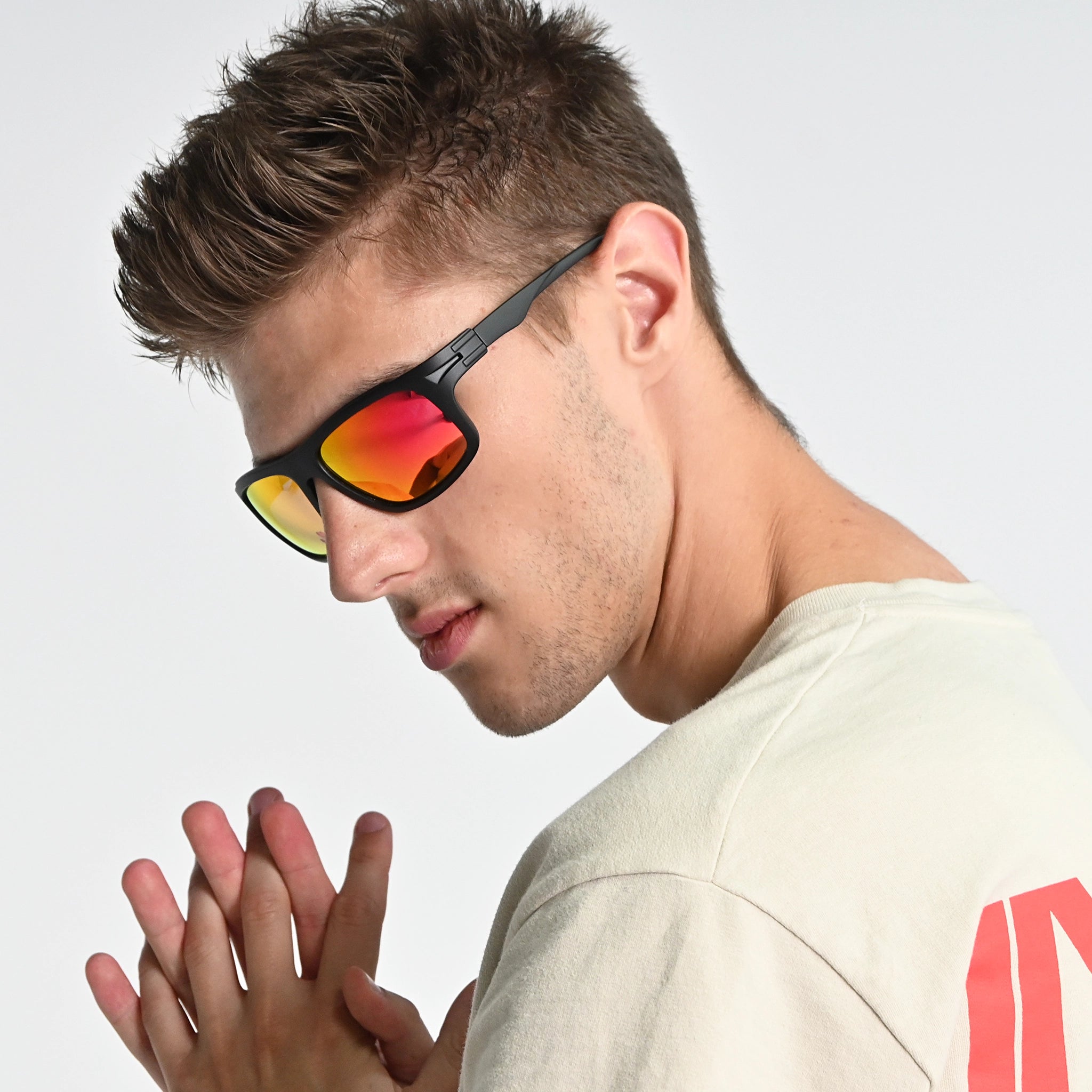 Man wearing reflective sunglasses with a neutral background