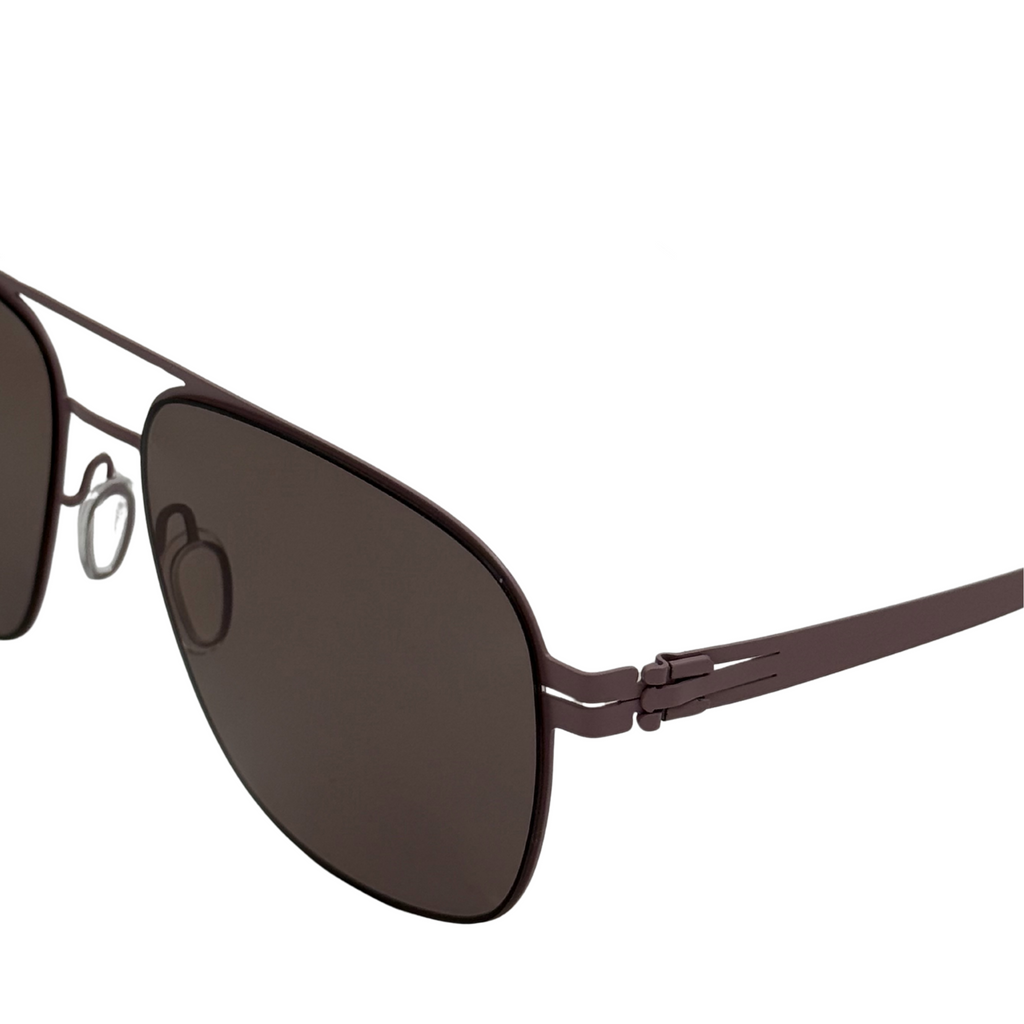 Sunglasses with dark lenses and thin metal frame on a white background