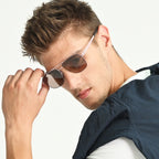 Man wearing sunglasses with a neutral background