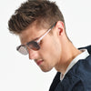 Man wearing sunglasses with a neutral background