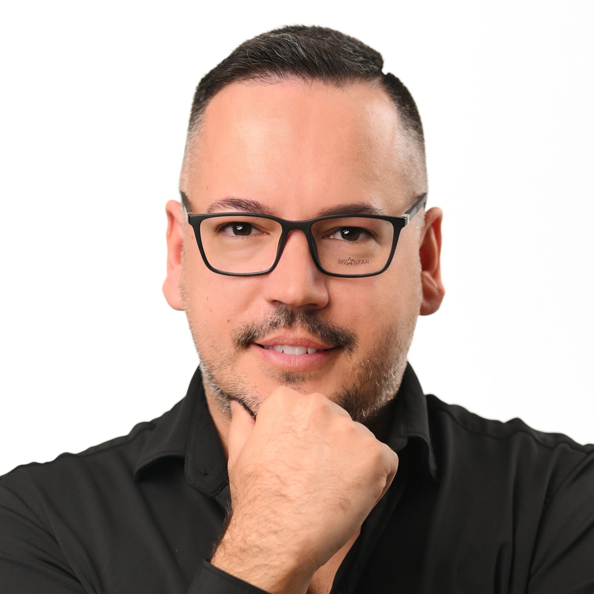 Man wearing glasses with a neutral background