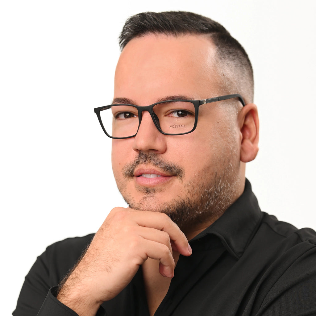 Man wearing glasses and a black shirt on a white background