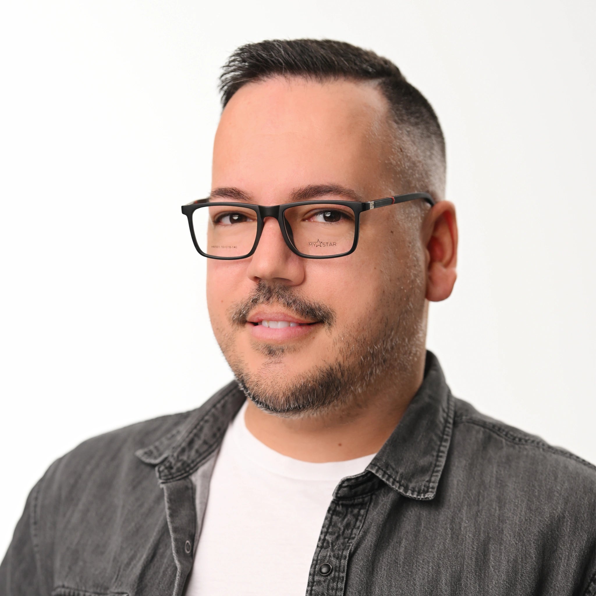 Man wearing glasses and a gray shirt on a white background