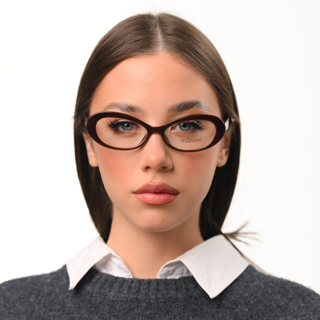 Woman wearing glasses with a plain background