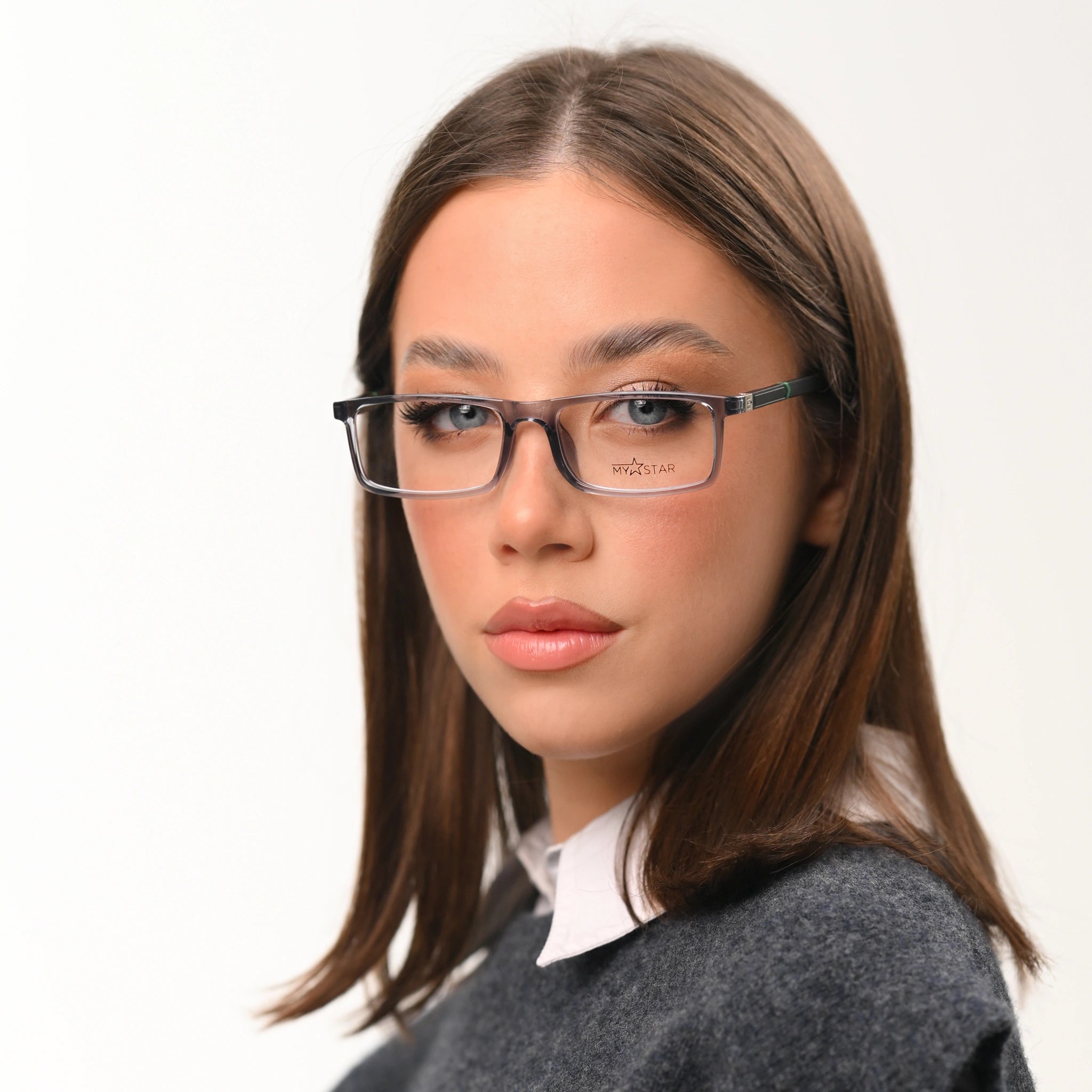 Woman wearing glasses with a plain background