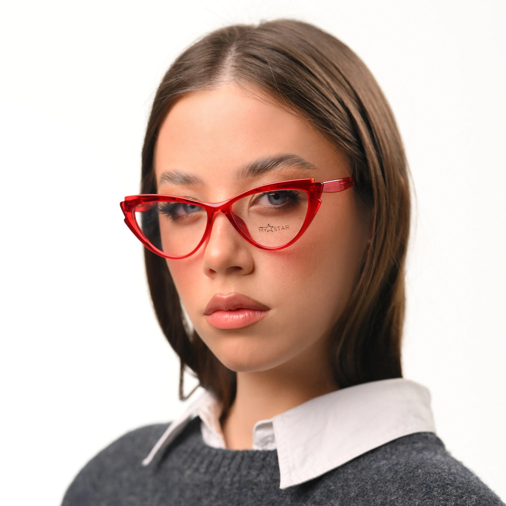 Woman wearing red cat-eye glasses on a white background