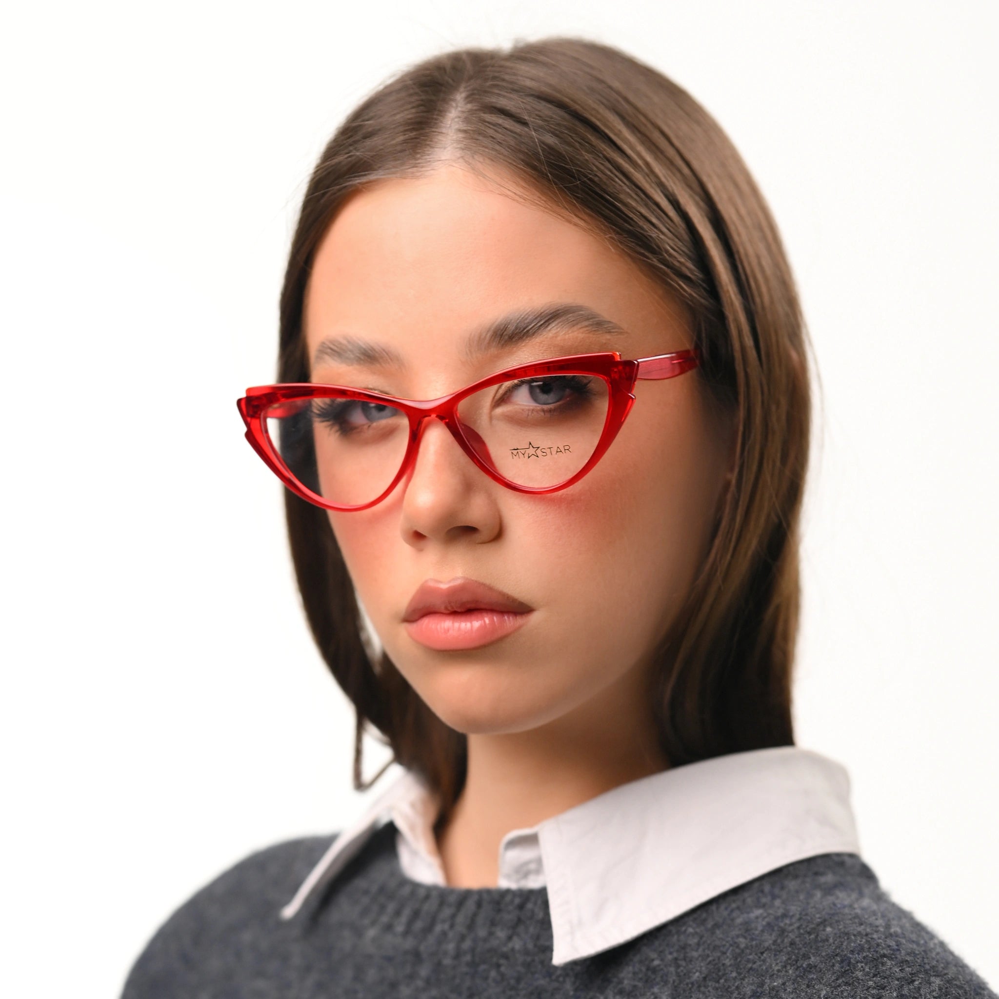 Woman wearing red cat-eye glasses on a white background