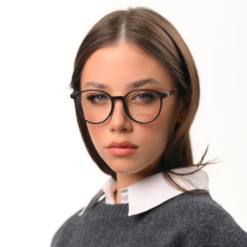 Woman wearing glasses with a neutral background