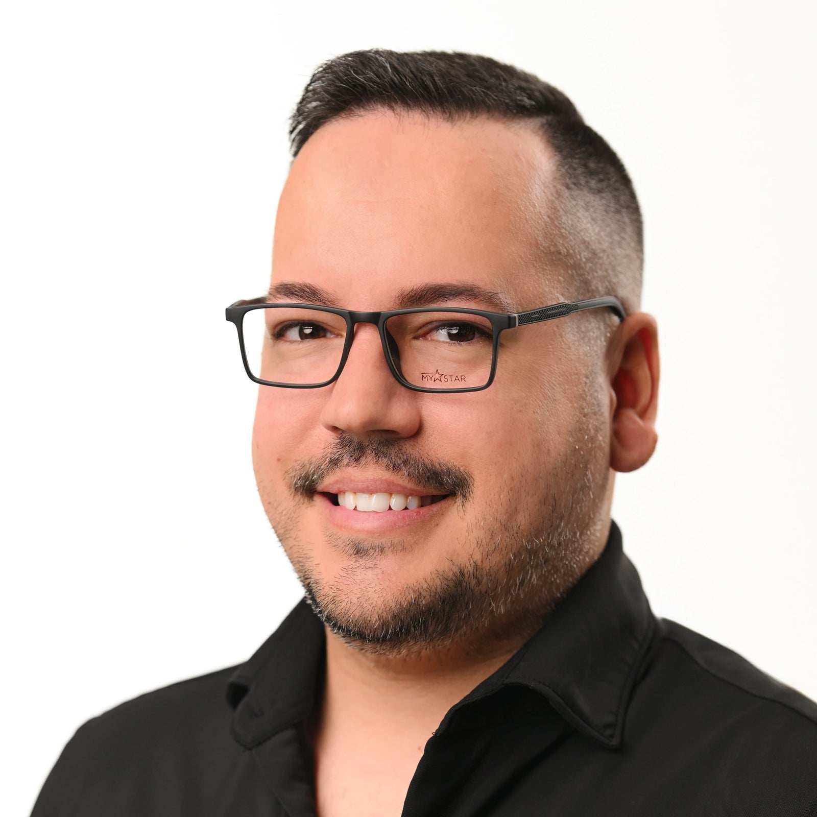 Man wearing glasses and a black shirt on a white background