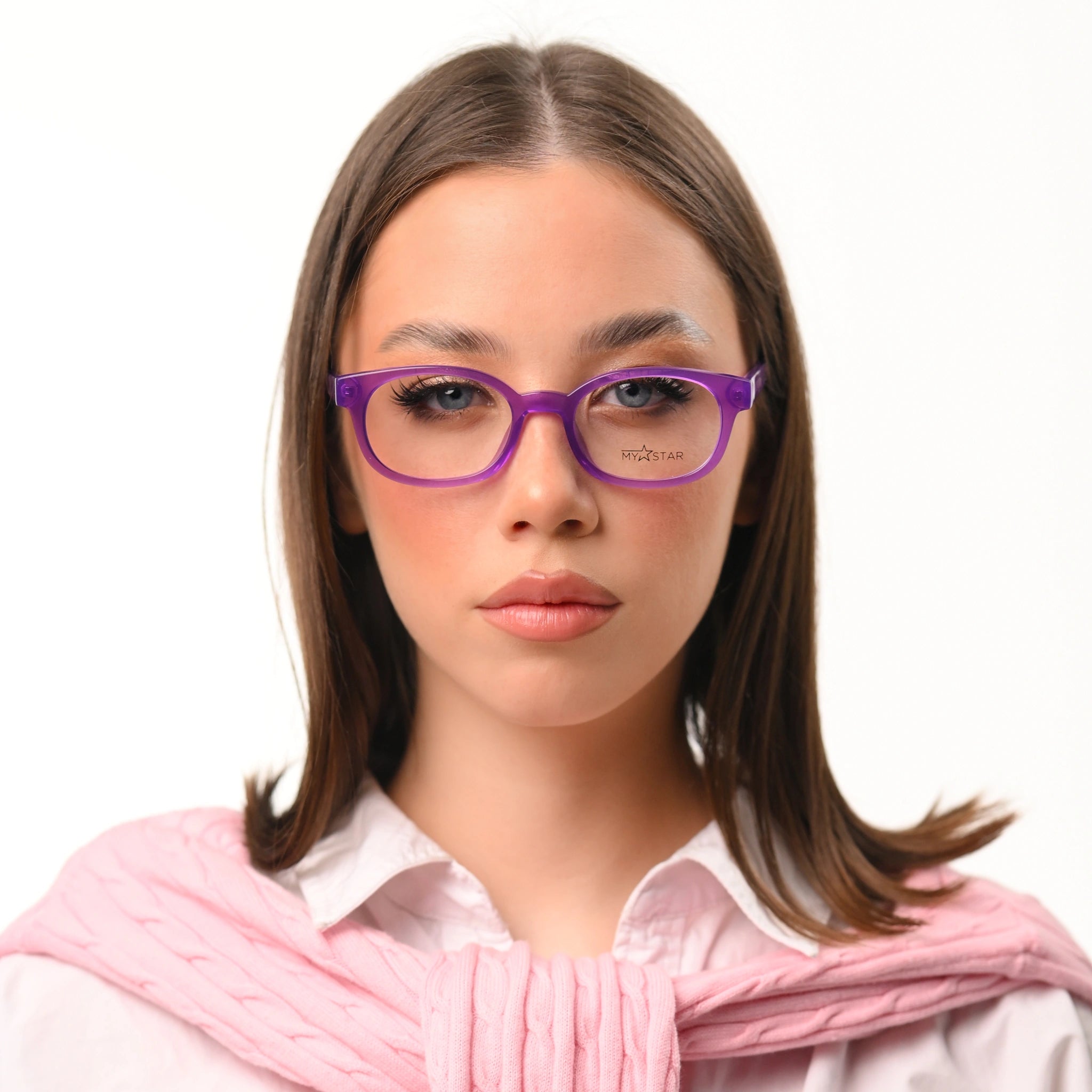 Woman wearing purple glasses and a pink scarf on a white background