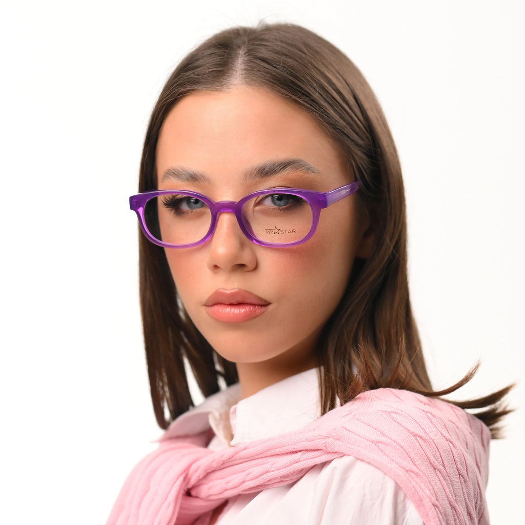 Woman wearing purple glasses and a pink scarf on a white background