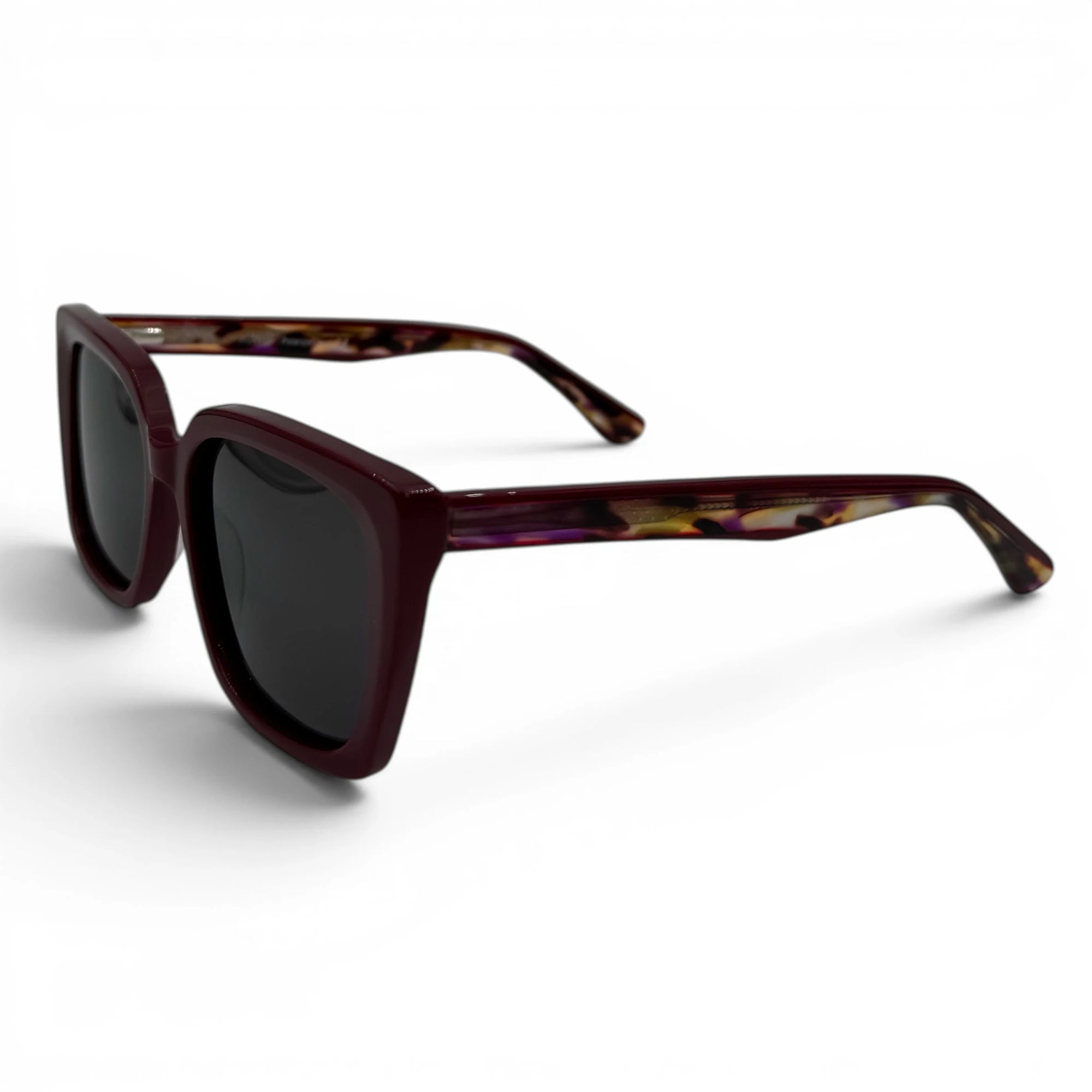 Sunglasses with tortoiseshell frame and dark lenses on a white background