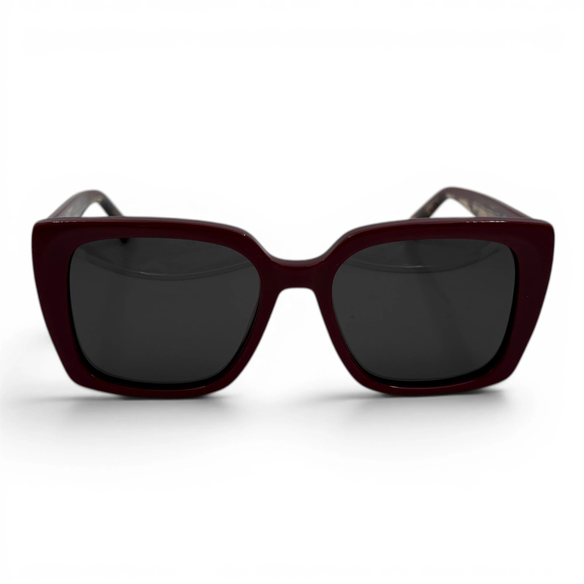 Sunglasses with a dark frame and dark lenses on a white background