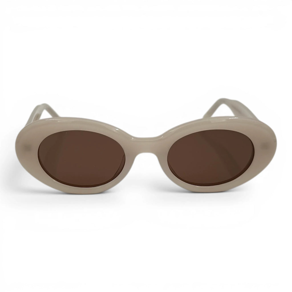 Beige sunglasses with brown lenses on a white background